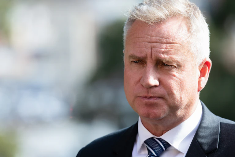 A man in a suit frowns