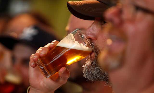 A man drinking a beer