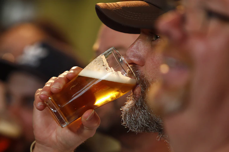 A man drinking a beer