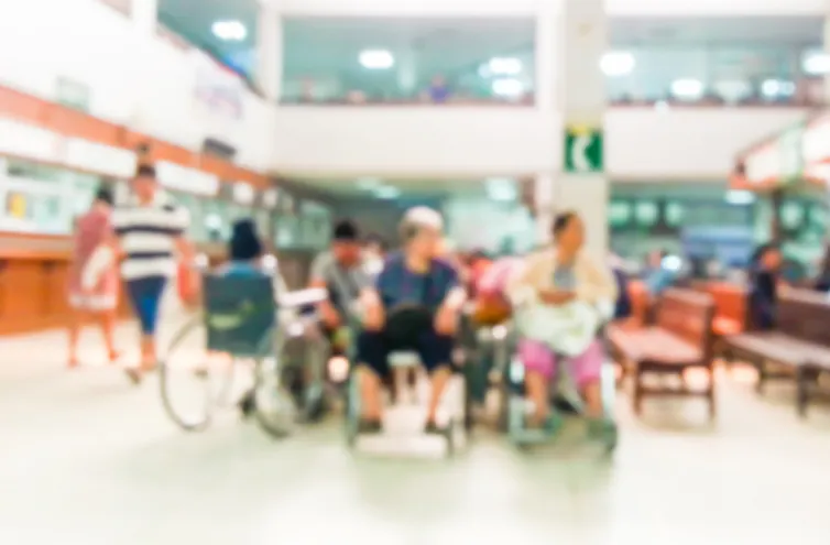 A blurred image of a hospital waiting room.