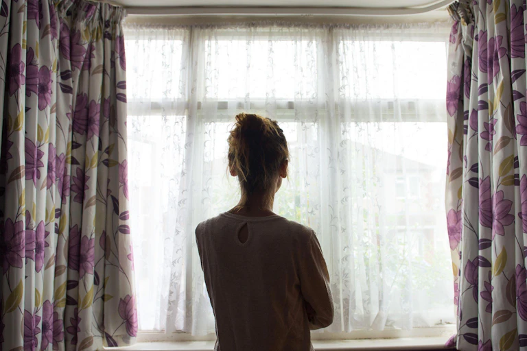 Woman looking out of a window