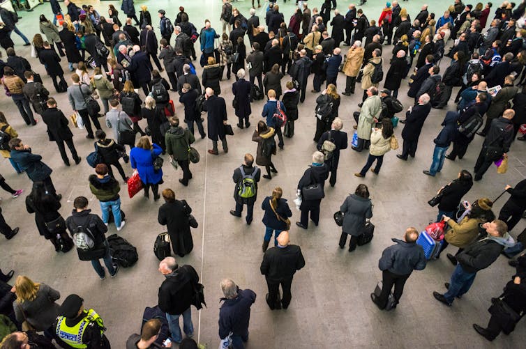A crowd at a station seen from above.