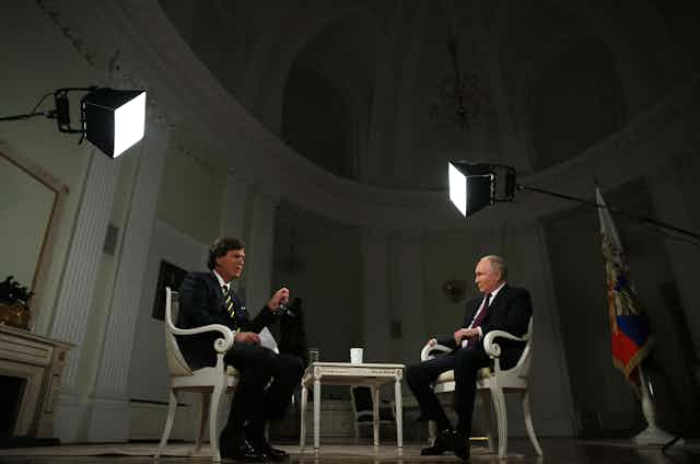 US journalist Tucker Calrson getures as he interviews Russian president Vladimir Putin, February 2024.