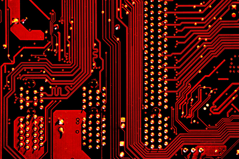 Close-up of a microchip with red lighting across it