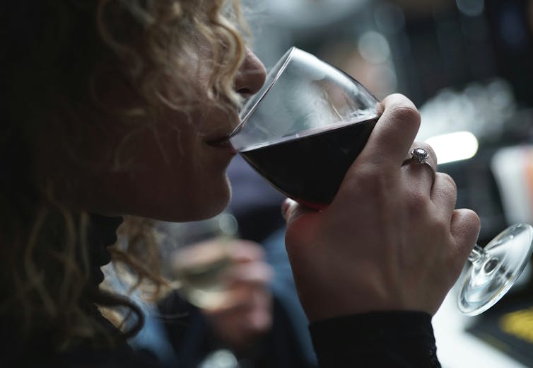 Woman sips red wine