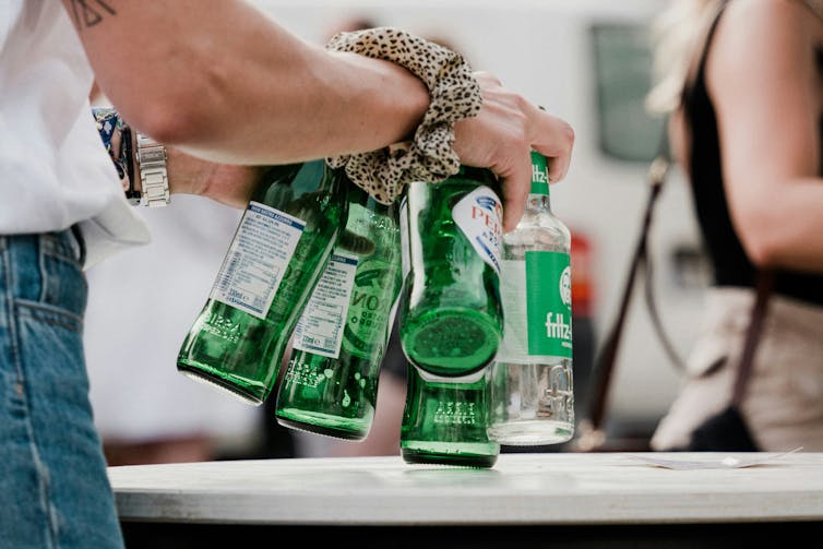 Woman collects beer bottles