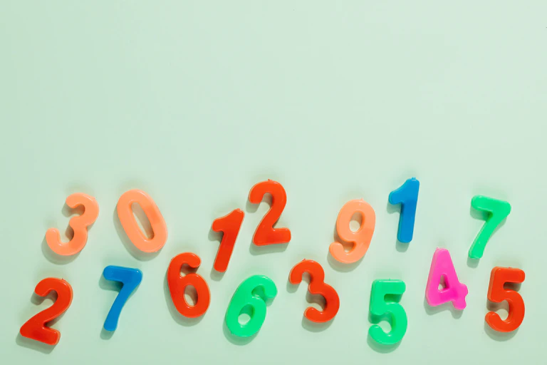 Magnet numerals, scattered on a plain background.