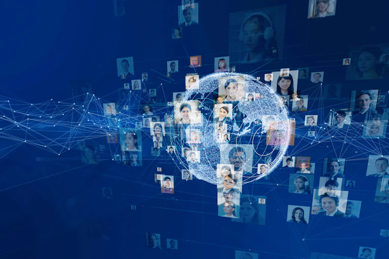 a globe on a blue background surrounded by diverse people's faces on a screen