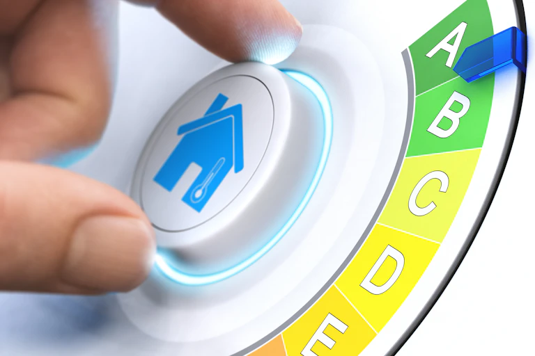 Hand turning dial to green A energy rating, blue house picture in centre of white dial