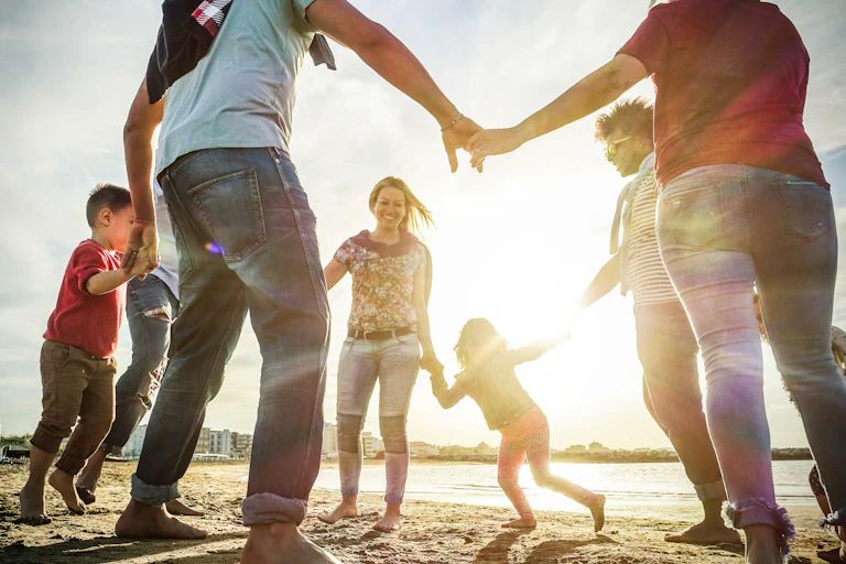 Adults and children playing on beach
