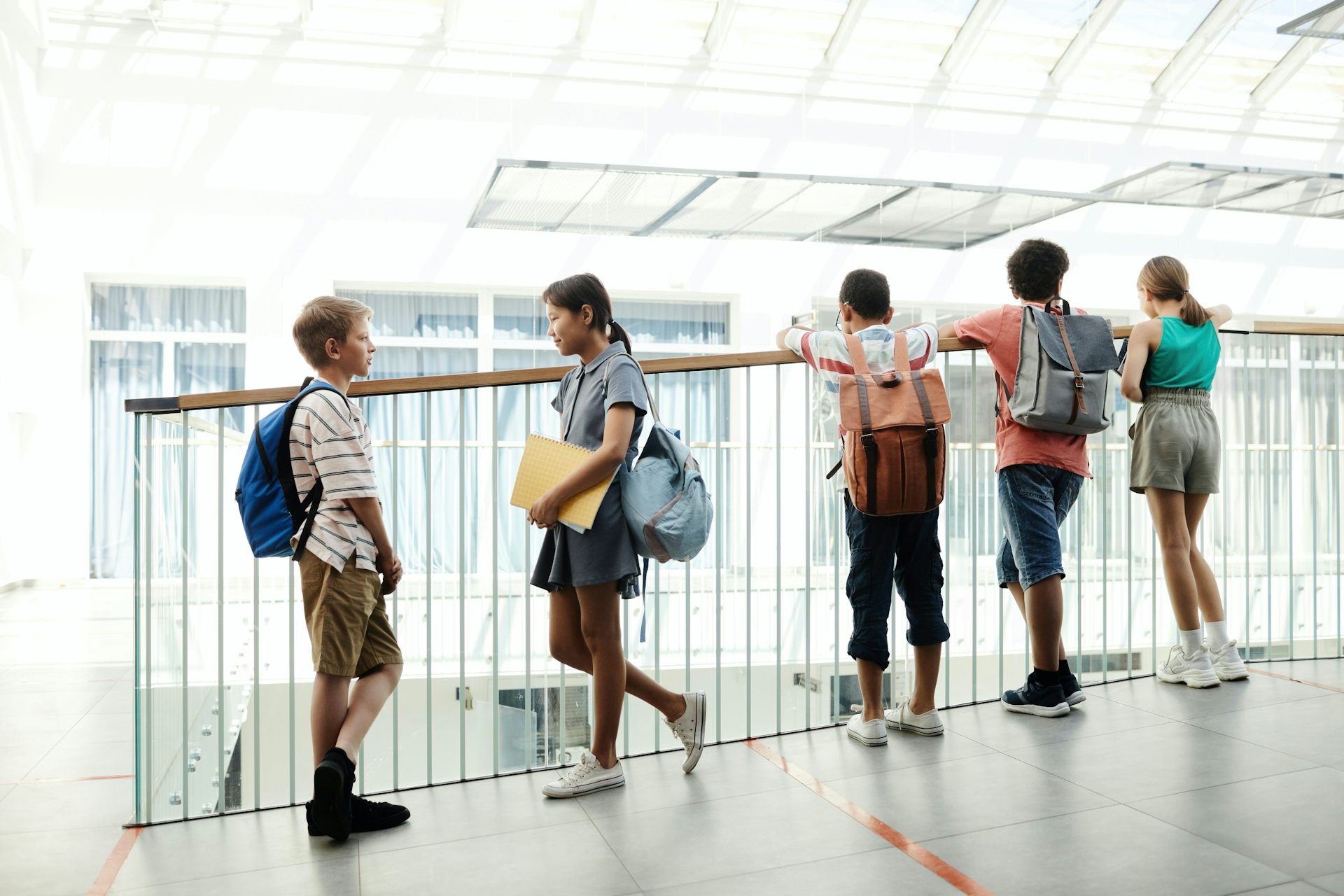 Students seen on a landing overlooking a foyer.