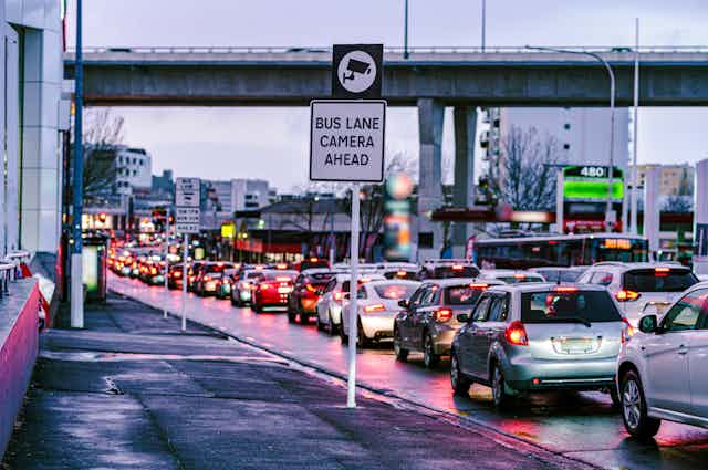 traffic jam on Auckland street with 'bus lane camera' sign