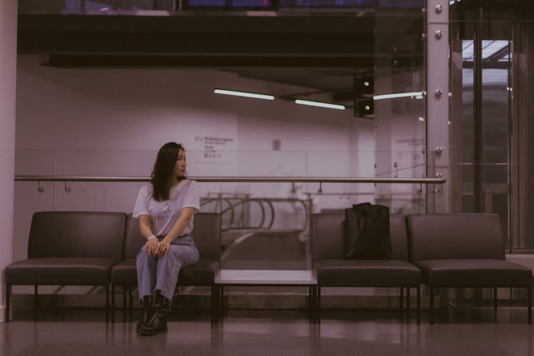 Woman sits in a medical waiting room