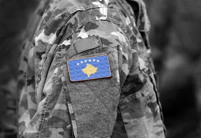 Flag of Kosovo on a soldiers arm.
