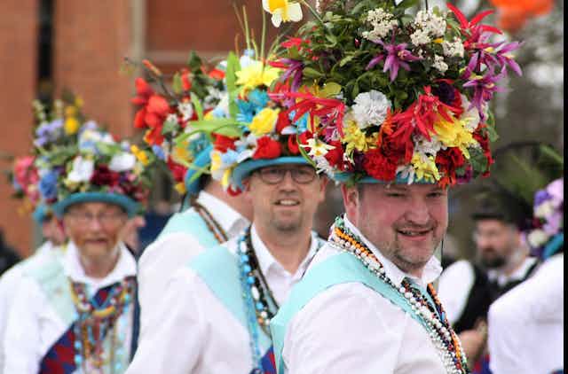 Morris dancers wearing floral hats