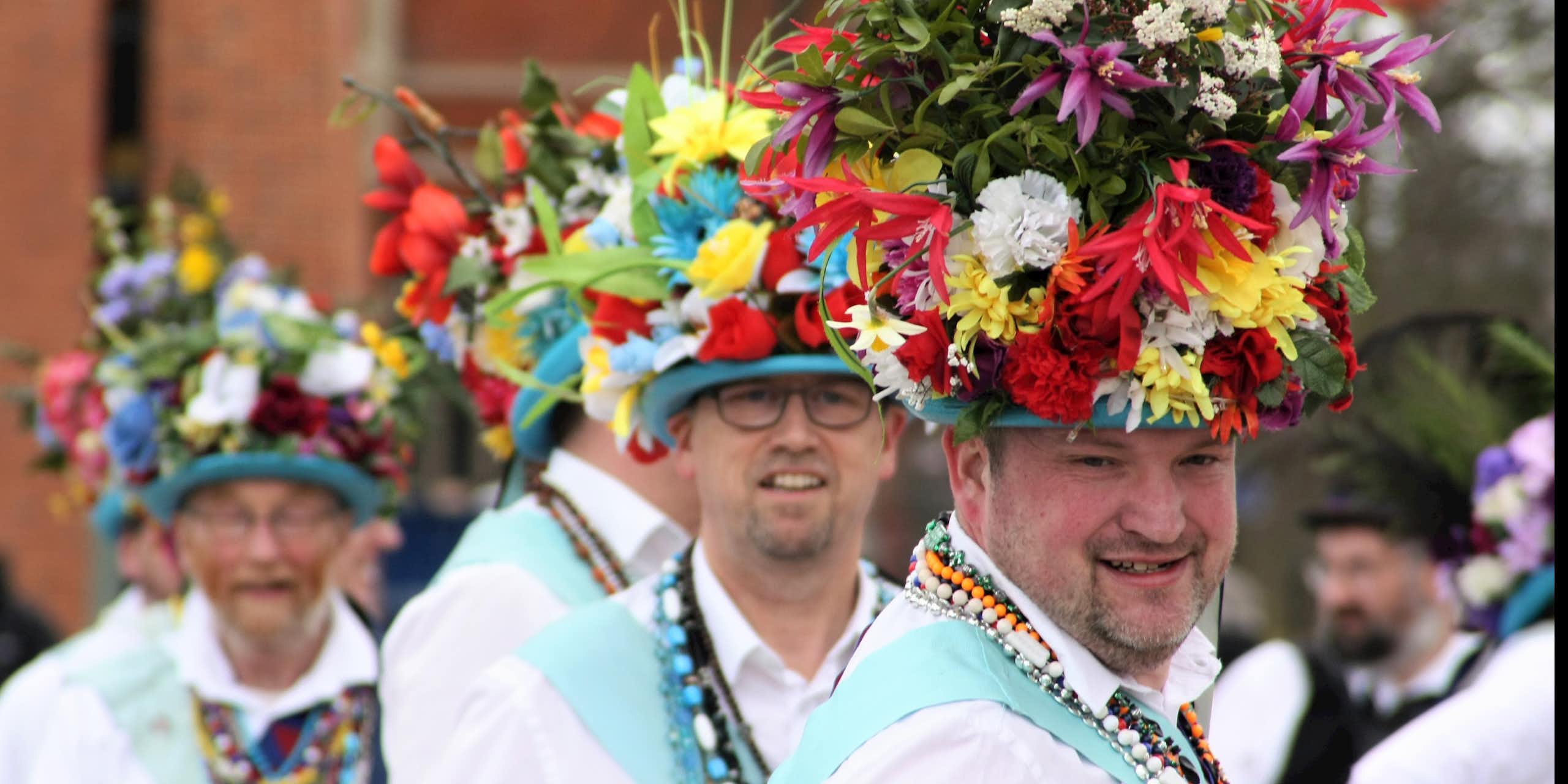 Morris dancers wearing floral hats