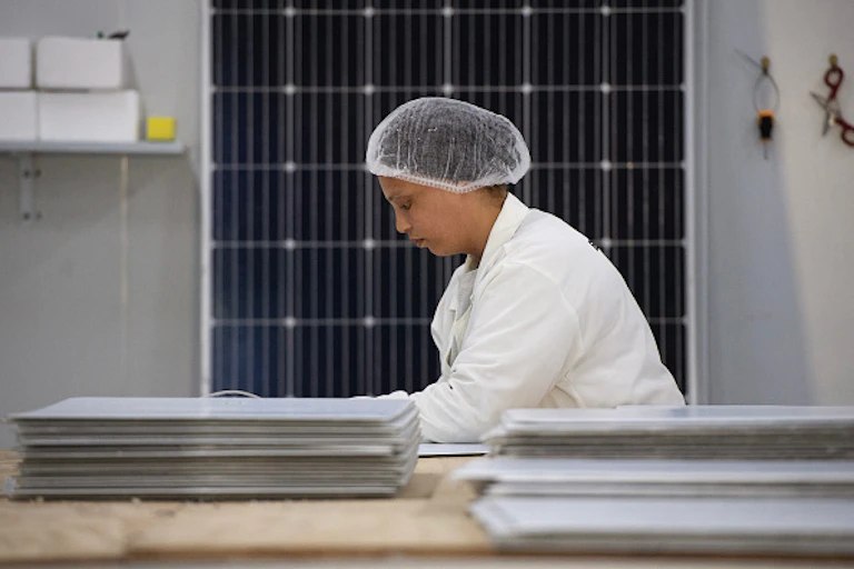 Woman in white coat and hair net