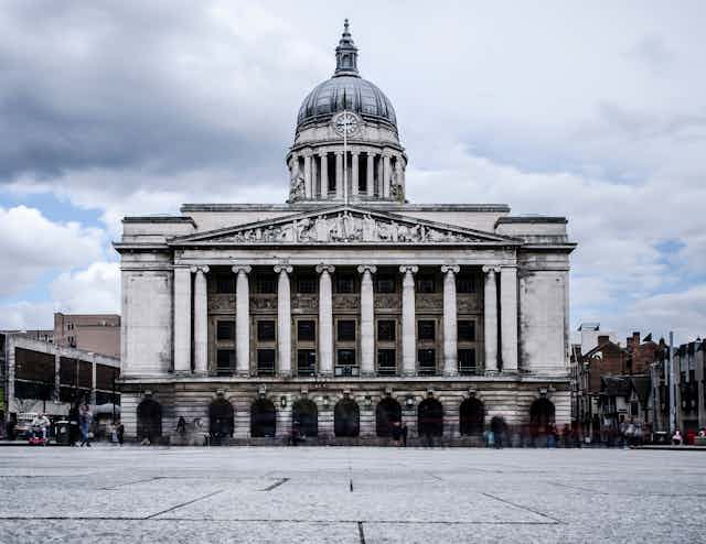 View of Nottingham Council House, a grand columned building with a large dome, against a grey sky