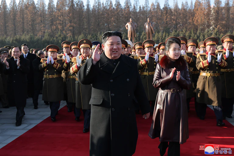North Korean leader Kim Jong-un with his daughter Kim Ju-ae and a crowd of army officers.
