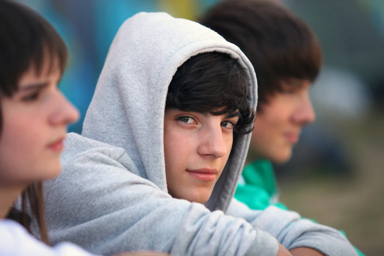 Teenagers, one teenage boy looking at camers