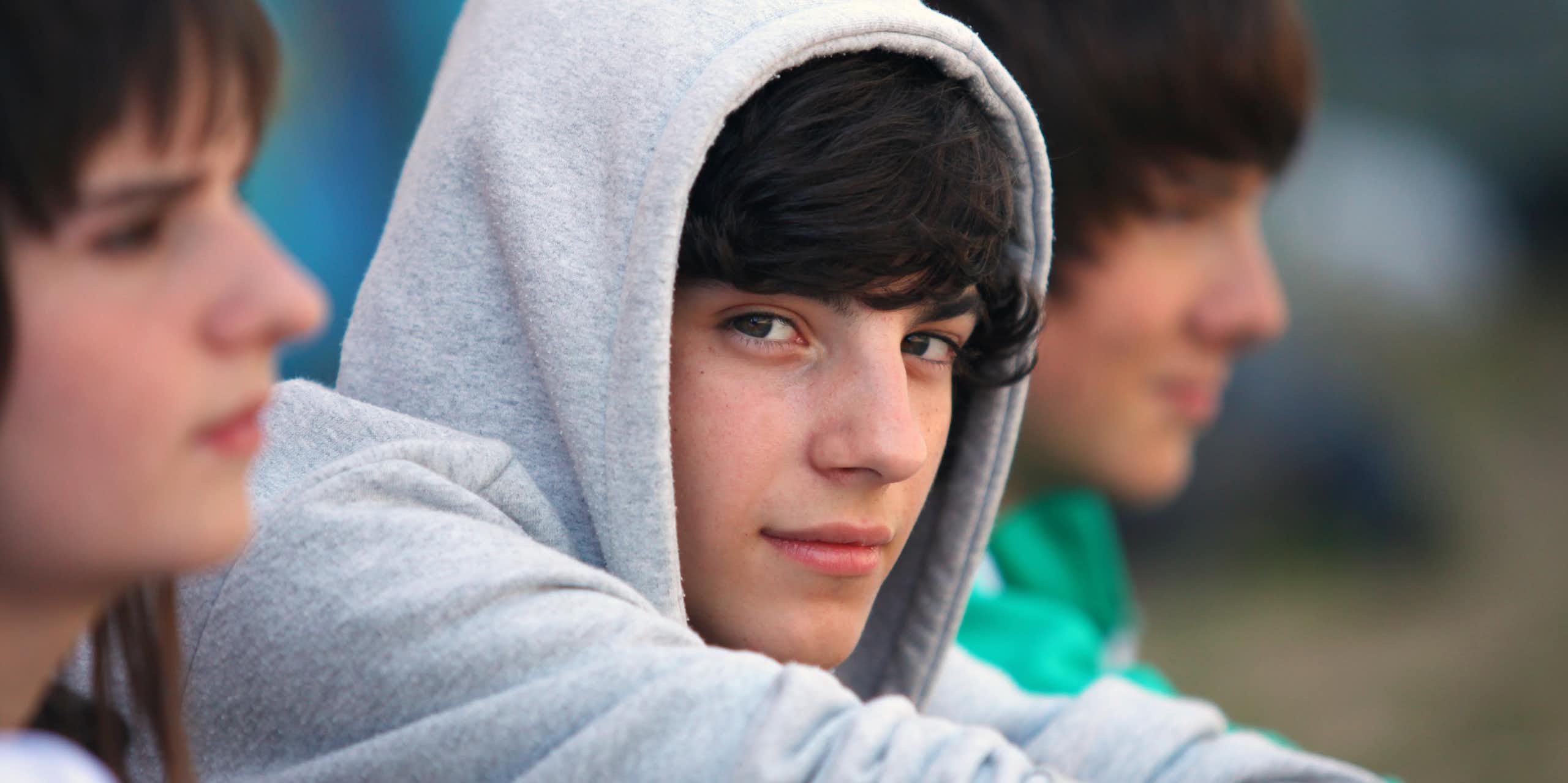 Teenagers, one teenage boy looking at camers