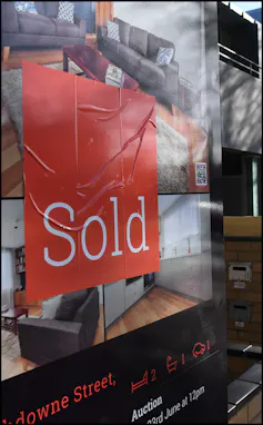 Photo of sign saying sold on residential property