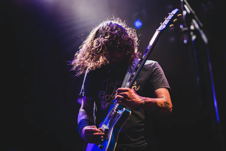 A man shreds a guitar.