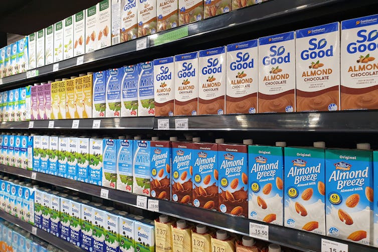 Supermarket shelves of plant-based milks