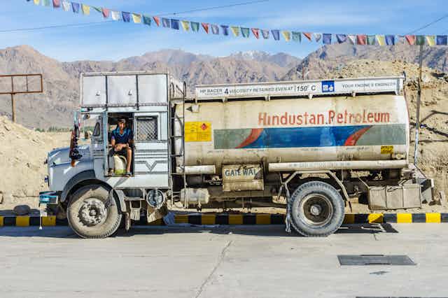 A petrol truck with bunting above it.