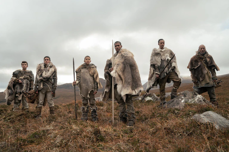 Six prehistoric humans in furs with spears