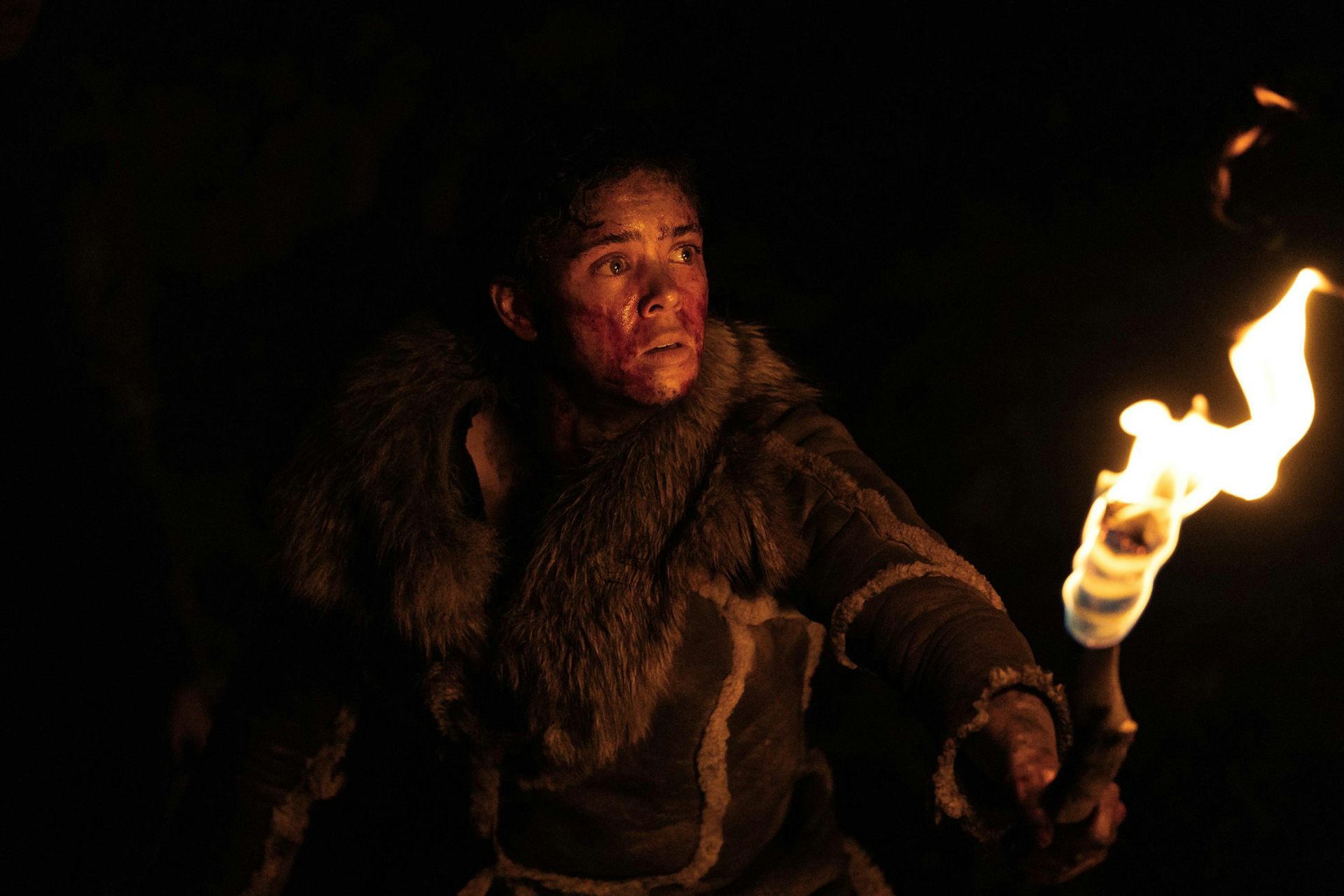 Stone Age woman holding lit torch