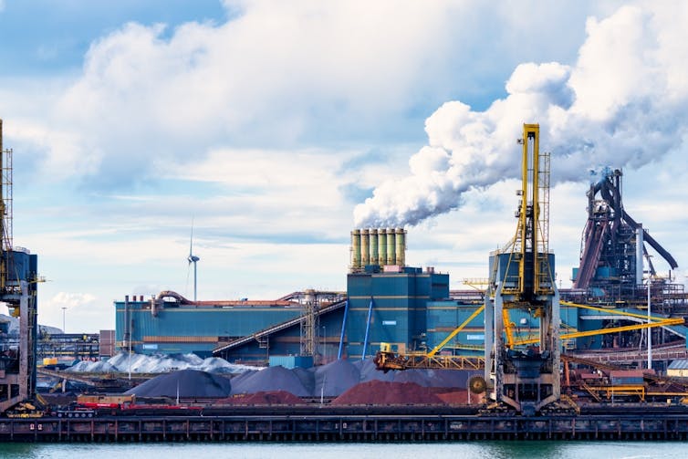 An industrial scene on the banks of a river.