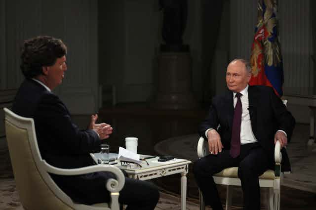 US journalist Tucker Carlson sits opposite Russian president Vladimir Putin