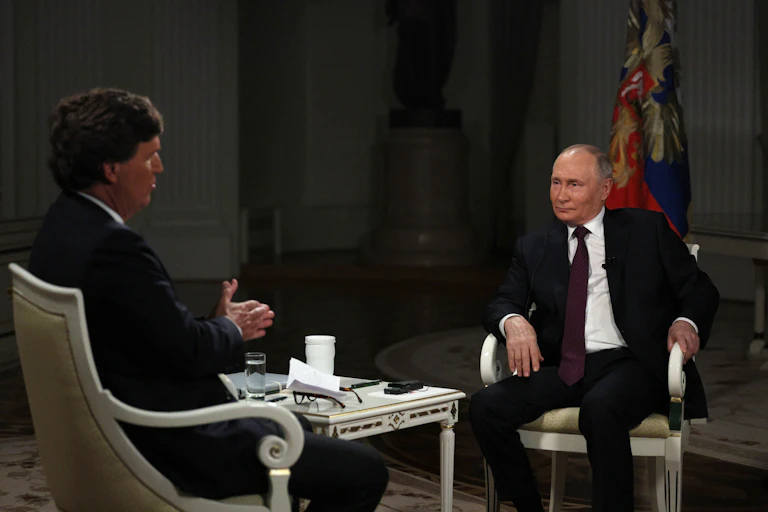 US journalist Tucker Carlson sits opposite Russian president Vladimir Putin