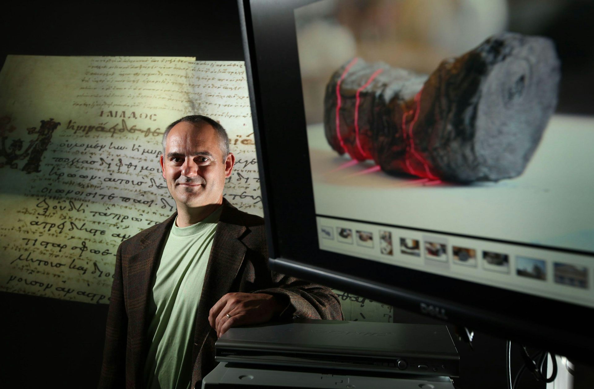 A professor with an image of a carbonised scroll.