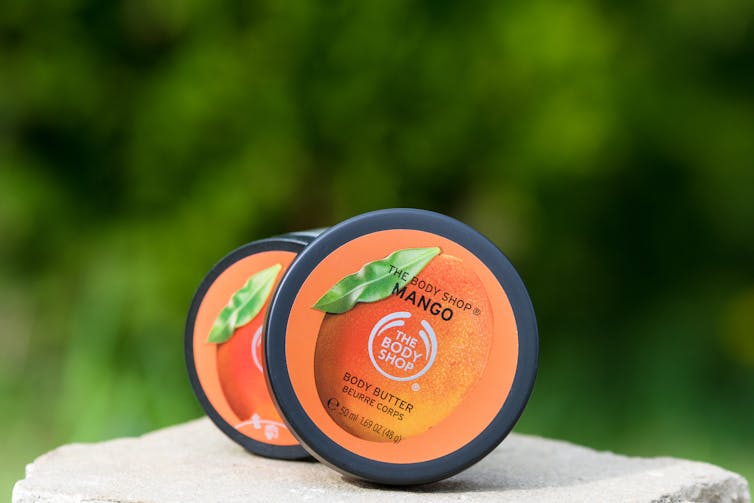 Two pots of Body Shop mango body butter.