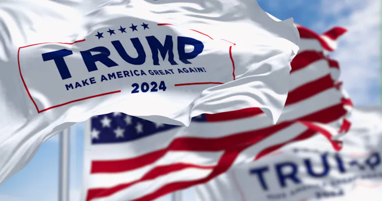 A white, red and blue flag, with Trump for president on it.