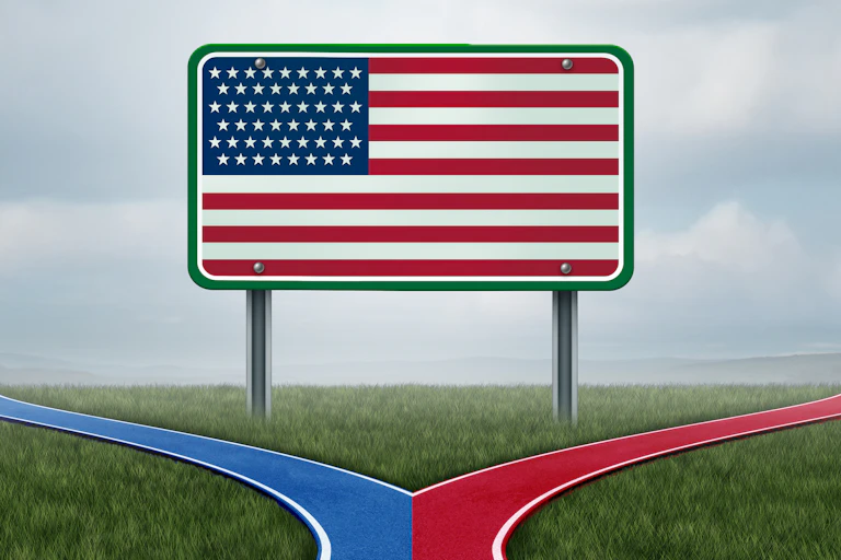 An American flag is painted on a billboard in a field, with blue and red paths leading away from it.