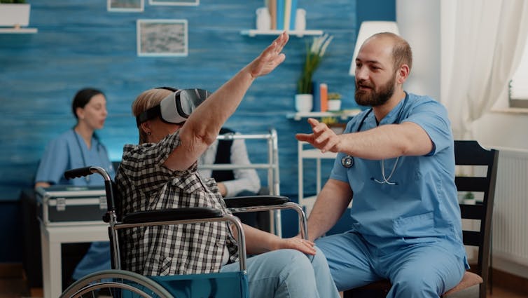 An older woman in a wheelchair uses VR.