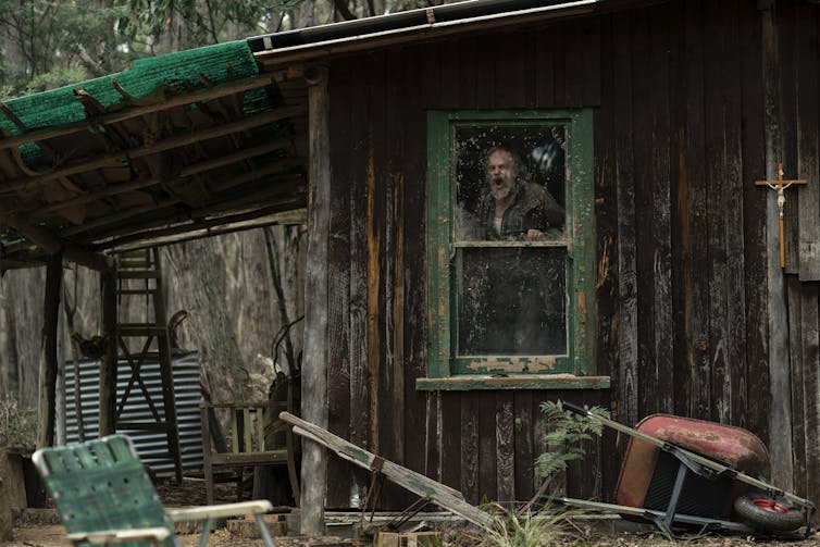 Hugo Weaving in a dilapidated structure.
