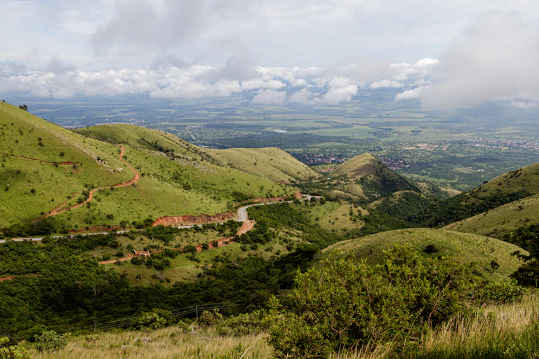 A photograph of a beautiful green, mountainous landscape stretching far into the distance