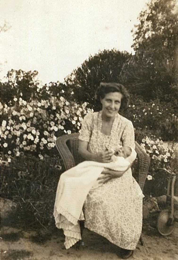 A black and white photo of a mother holding her baby.