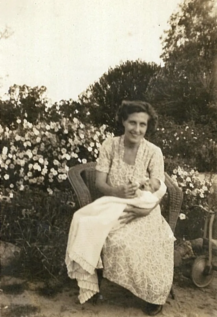 A black and white photo of a mother holding her baby.
