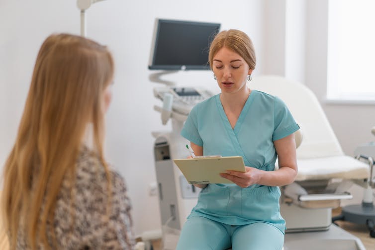 Gynaecologist talks to patient