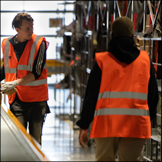 Photo of worker in hi-vis jacket picking stock