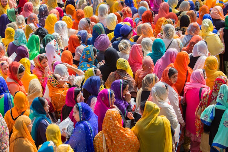 A crowd of women in colourful saris.
