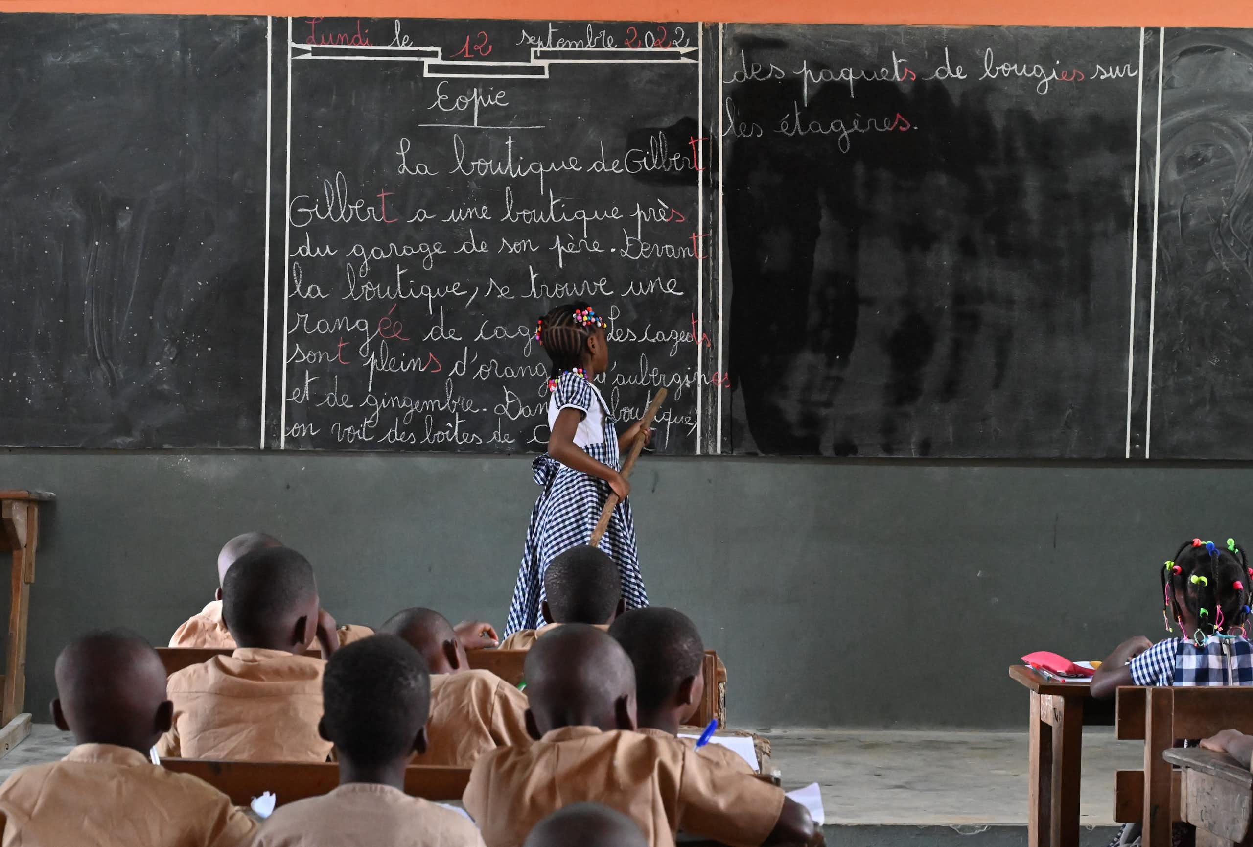 A girl standing in front of a blackboard