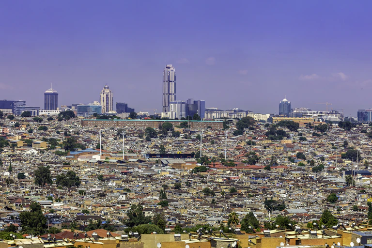 View of an urban landscape with tall buildings and crowded small dwellings
