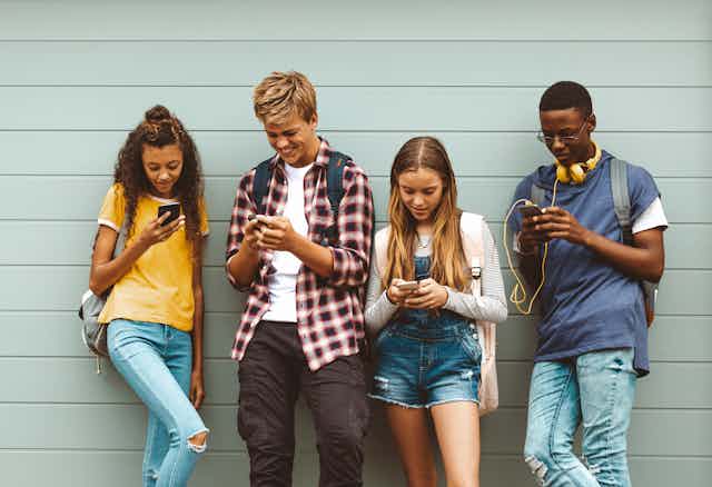 Teenagers looking at phones