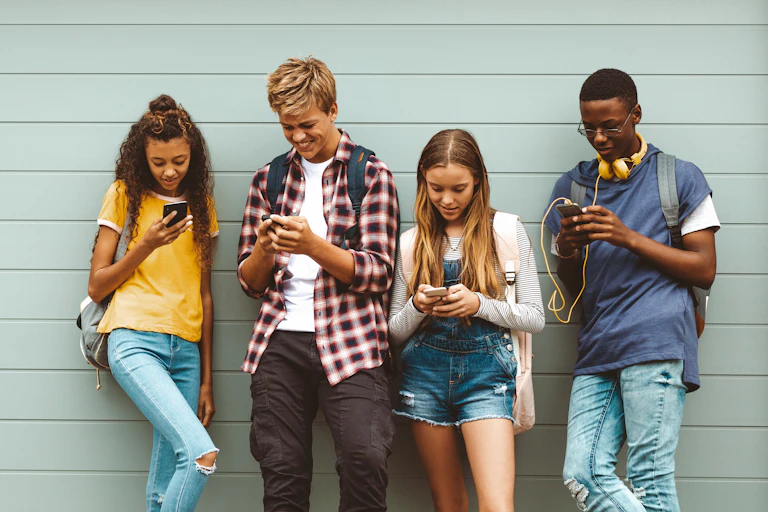 Teenagers looking at phones